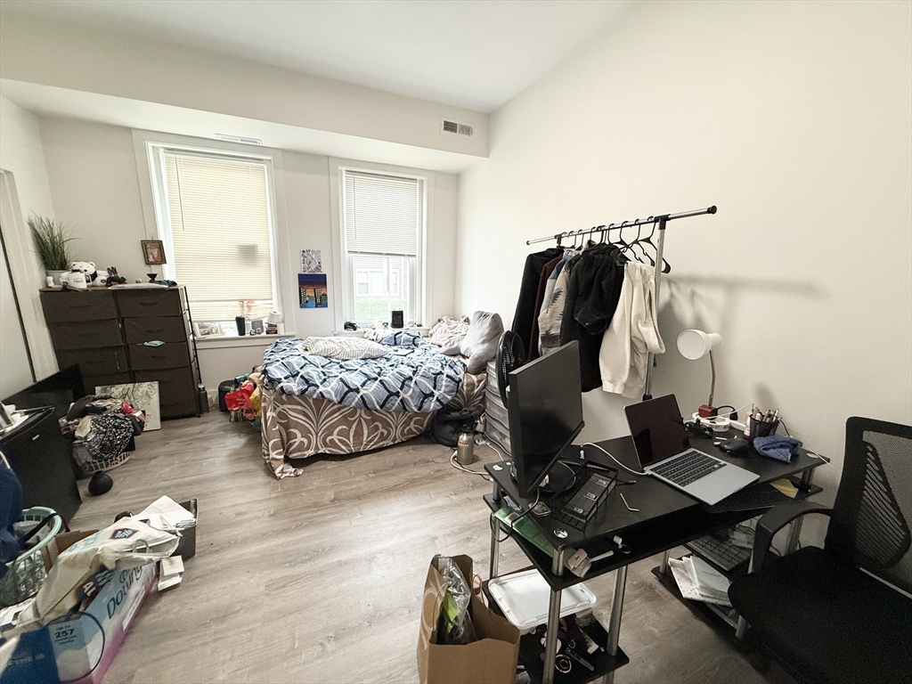 301-305 Dudley Street, Unit 2 Boston, MA 02119 - Photo 6 of 10 a bedroom with furniture and a window