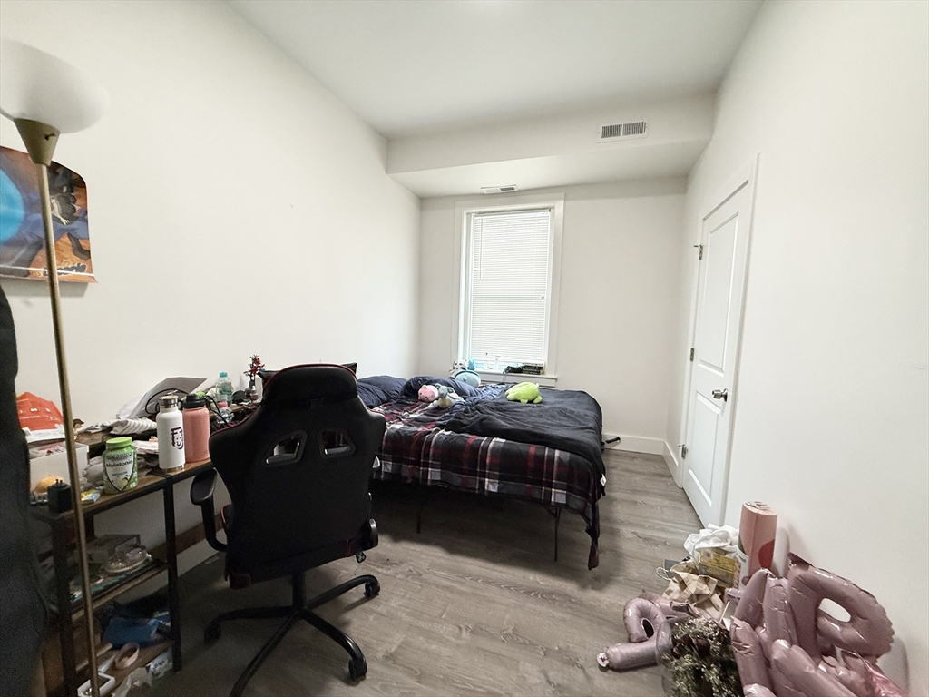 301-305 Dudley Street, Unit 2 Boston, MA 02119 - Photo 7 of 10 a living room with furniture and a window