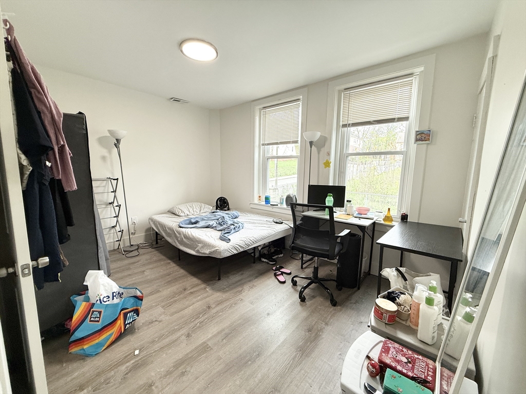 301-305 Dudley Street, Unit 2 Boston, MA 02119 - Photo 8 of 10 a living room with furniture and a flat screen tv