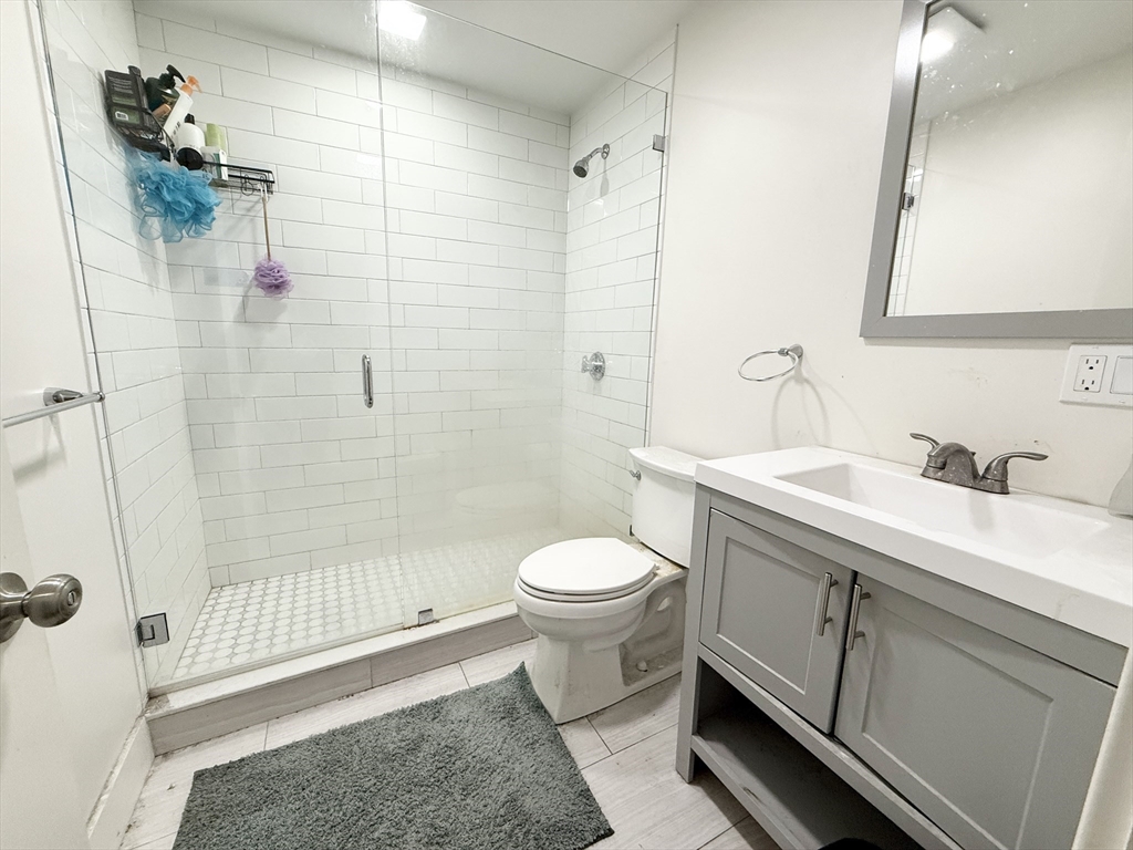 301-305 Dudley Street, Unit 2 Boston, MA 02119 - Photo 9 of 10 a bathroom with a sink toilet and shower