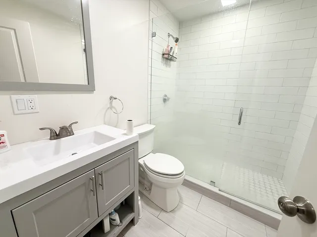 a bathroom with a sink toilet and shower