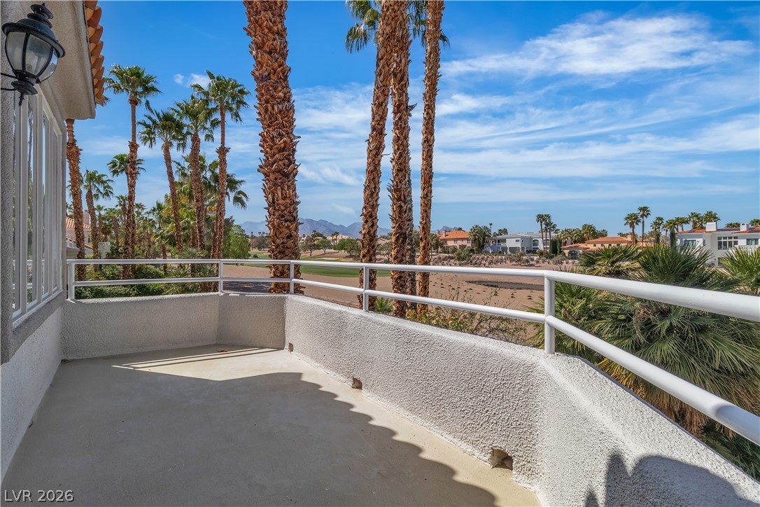 8848 Rainbow Ridge Drive Las Vegas, NV 89117 - Photo 37 of 43 A spacious private balcony offers captivating views of a verdant golf course and distant mountain ranges.