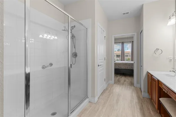 a bathroom with a sink and a glass door shower