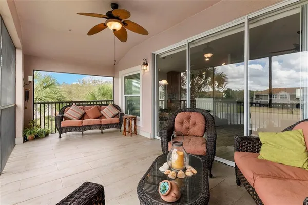 a living room with furniture and a floor to ceiling window