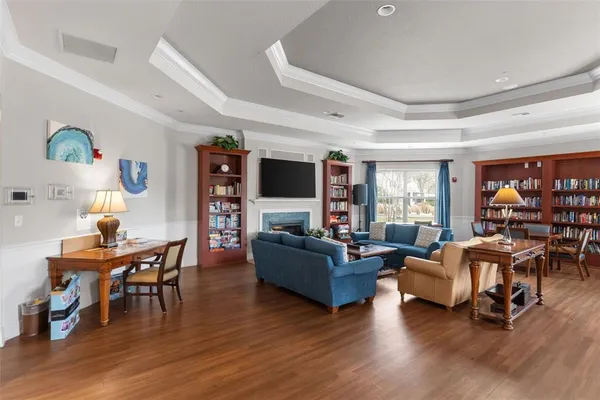 a living room with furniture and a flat screen tv with wooden floor