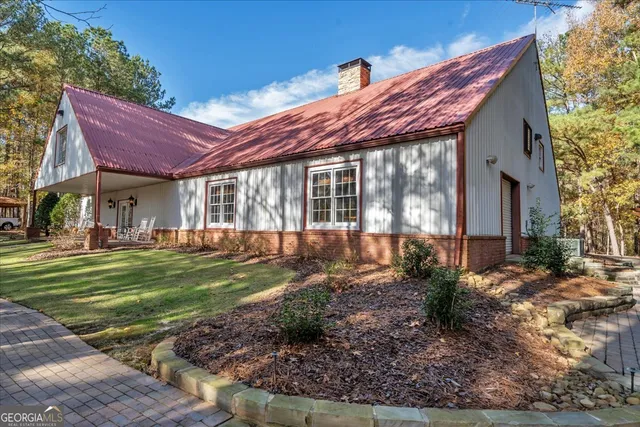 a bedroom with a bed ceiling fan and a large mirror
