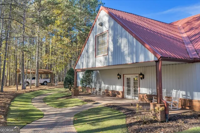 a bedroom with a bed ceiling fan and a large mirror
