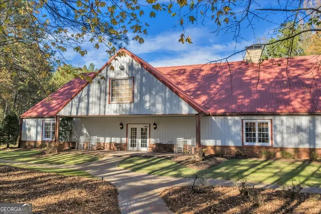 a living room with furniture a ceiling fan and a window