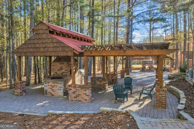 a bathroom with a granite countertop sink toilet mirror and shower
