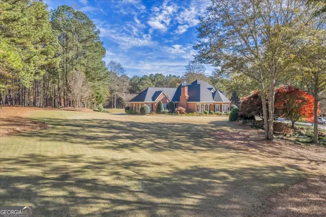 a bathroom with a granite countertop sink mirror vanity and toilet