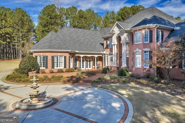 a kitchen with sink a refrigerator and chairs