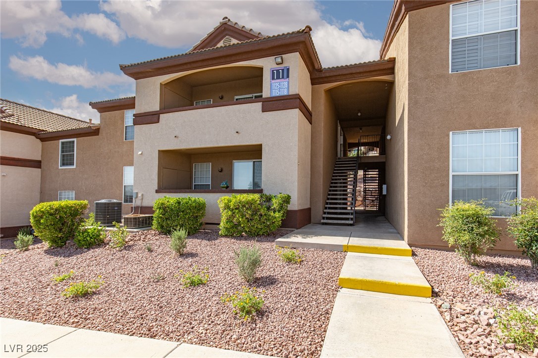 Property entrance with stucco siding and a tiled roof