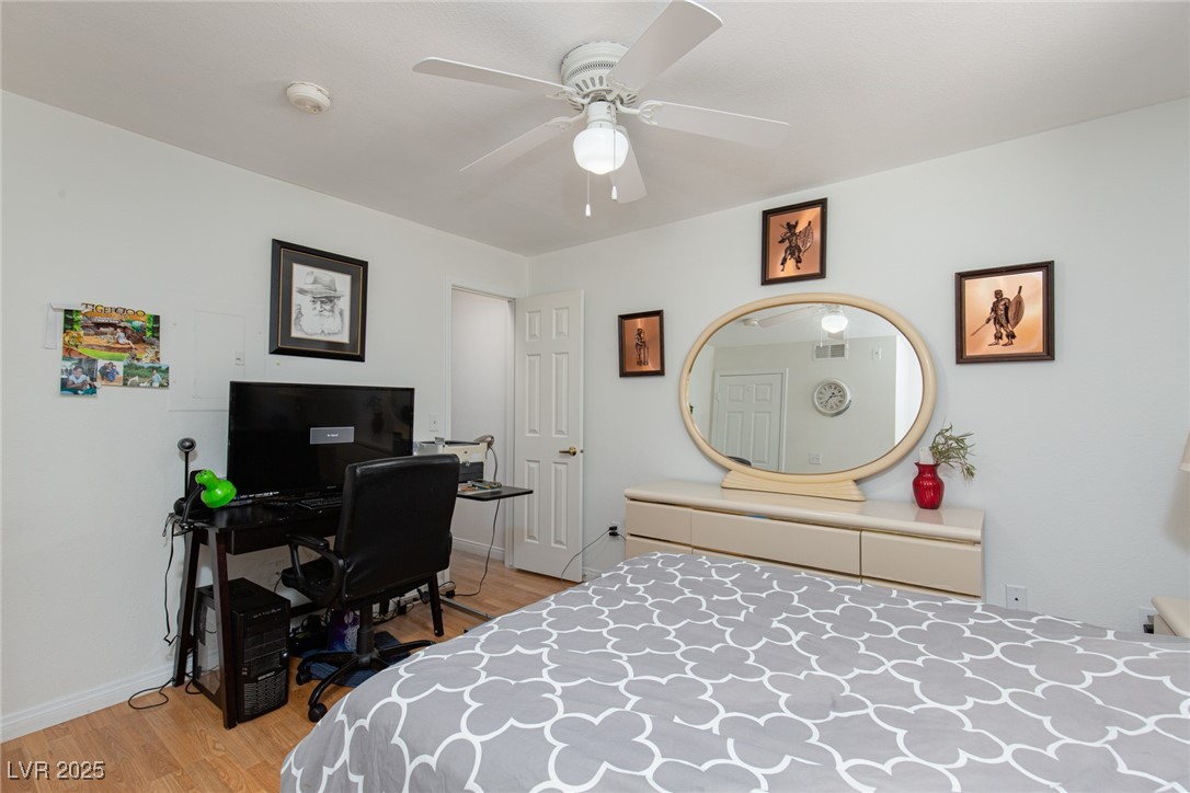 231 West Horizon Ridge Parkway, Unit 1126 Henderson, NV 89012 - Photo 12 of 33 Bedroom with light wood-style floors, a desk, and ceiling fan