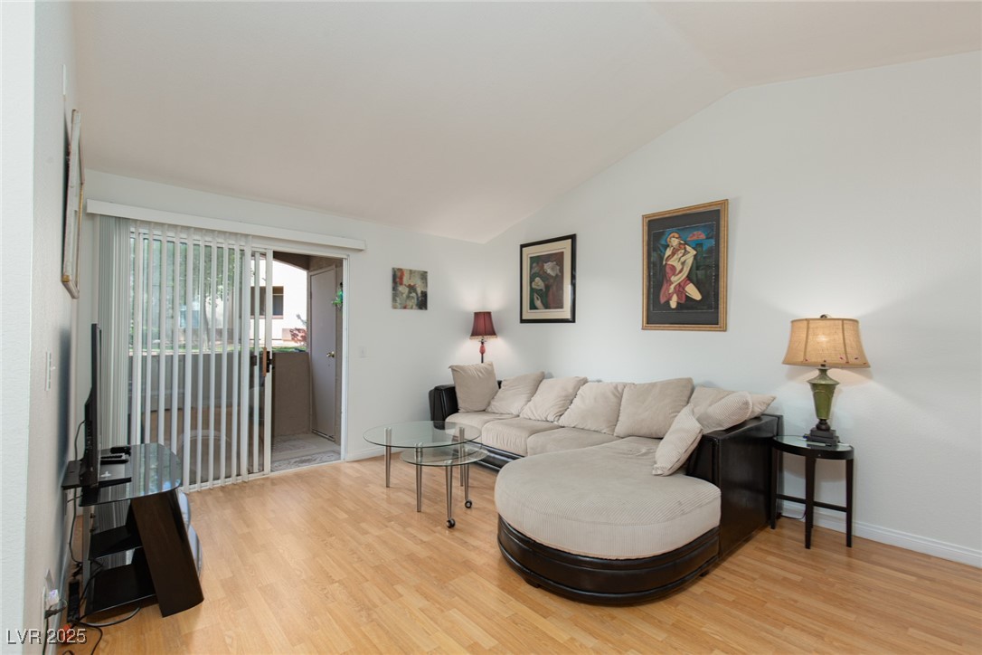 231 West Horizon Ridge Parkway, Unit 1126 Henderson, NV 89012 - Photo 5 of 33 Living area featuring lofted ceiling and light wood-style floors