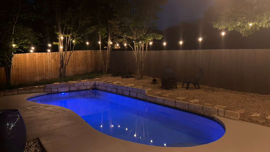9024 Heiden Lane Austin, TX 78749 - Photo 22 of 28 Curved swimming pool with stone coping and surrounding concrete decking