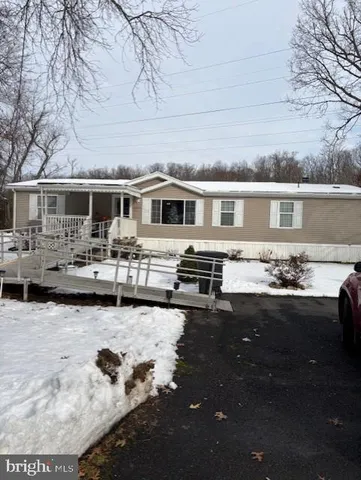 a front view of house with yard patio and outdoor seating