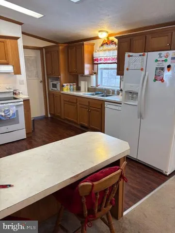 a kitchen with a stove a sink and a refrigerator