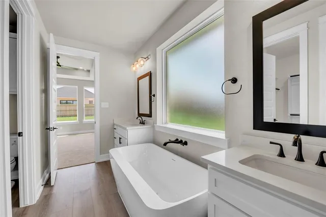a bathroom with a double vanity sink and mirror