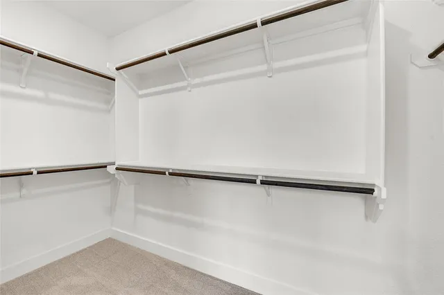 a bathroom with a double vanity sink a mirror and a bathtub