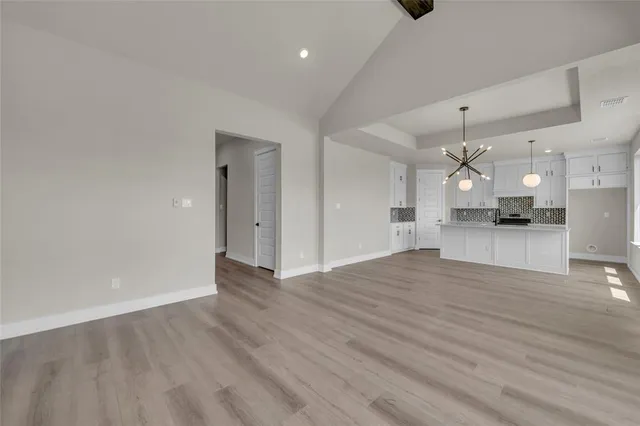 a view of a kitchen and an empty room