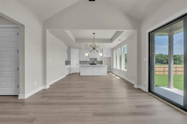 a view of a kitchen with a sink and wooden floor