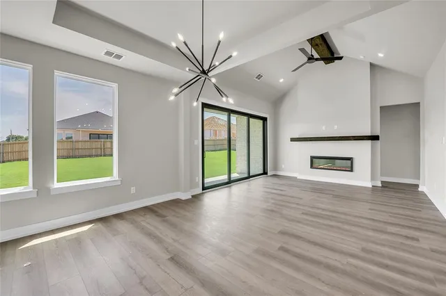 a kitchen with stainless steel appliances granite countertop a sink a stove and a wooden floors