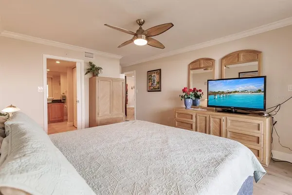 a bedroom with a bed and a flat screen tv