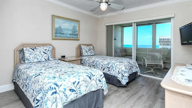 a bedroom with two beds and a large mirror