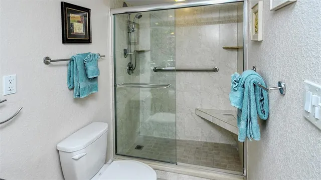 a bathroom with a shower and toilet