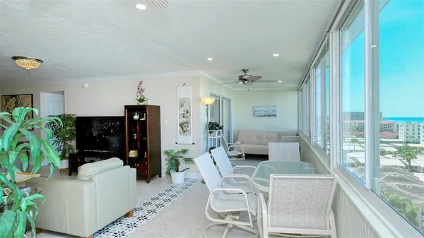 a living room with furniture and potted plant