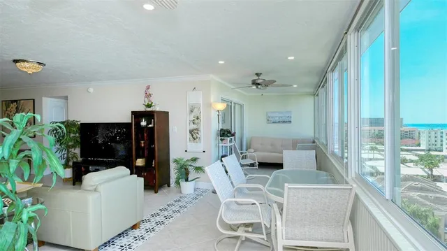 a living room with furniture and potted plant