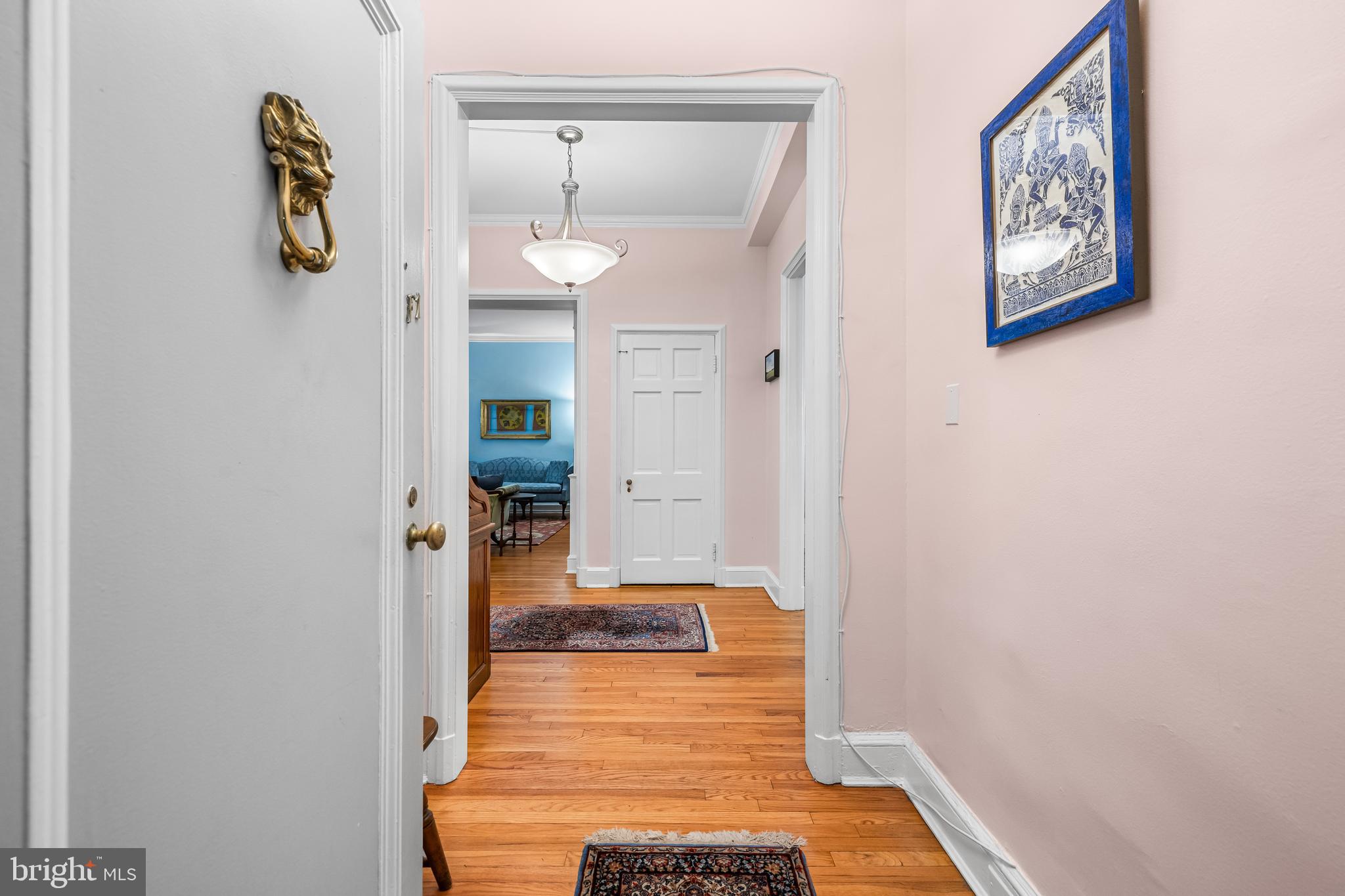 6 Upland Road, Unit F1 Baltimore, MD 21210 - Photo 3 of 50 a hallway with kids room bathroom and wooden floor