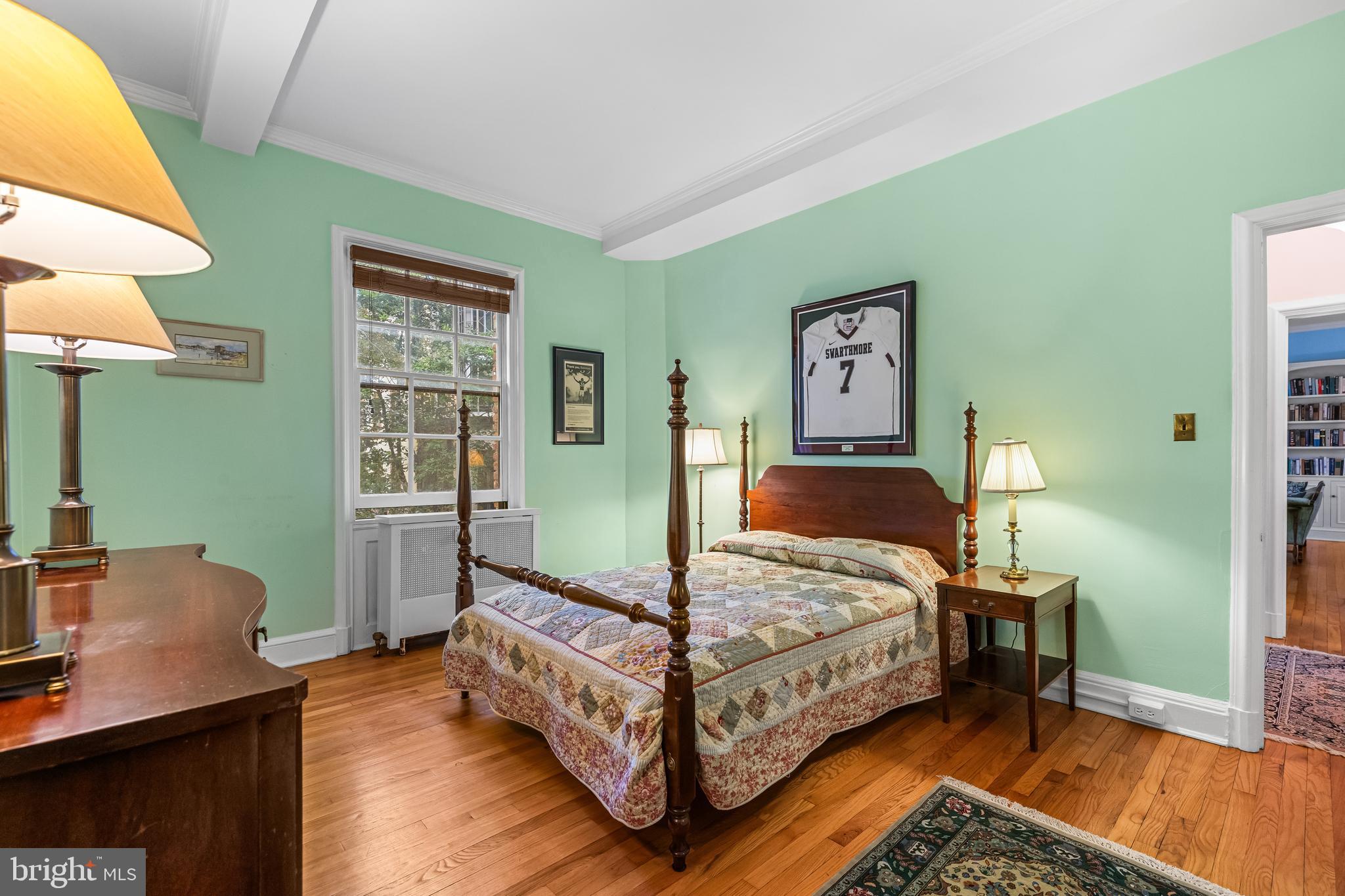 6 Upland Road, Unit F1 Baltimore, MD 21210 - Photo 34 of 50 a bedroom with a bed and wooden floor