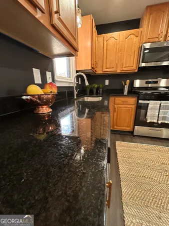 a kitchen with stainless steel appliances a sink a stove and a refrigerator