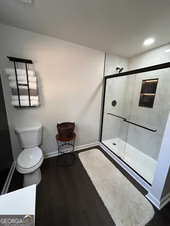 a bathroom with a toilet a sink and mirror