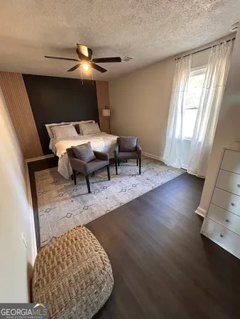 a bedroom with furniture and wooden floor