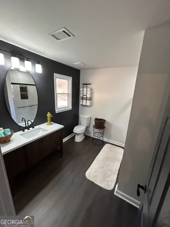 a living room with furniture and a mirror