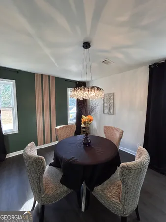 a dining room with furniture and window