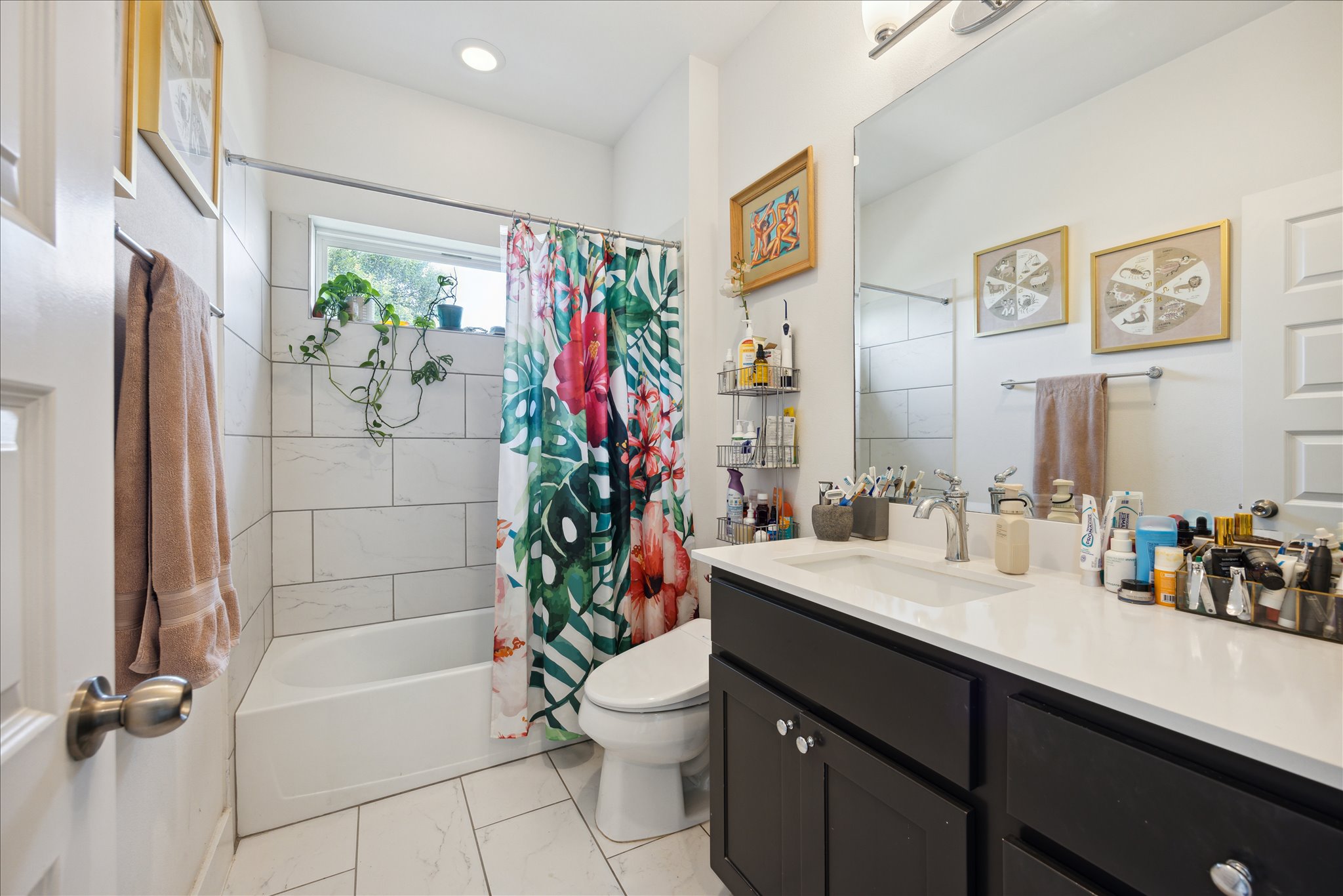 5006 Baker Street, Unit B Austin, TX 78721 - Photo 12 of 16 a bathroom with a sink a toilet and a large mirror