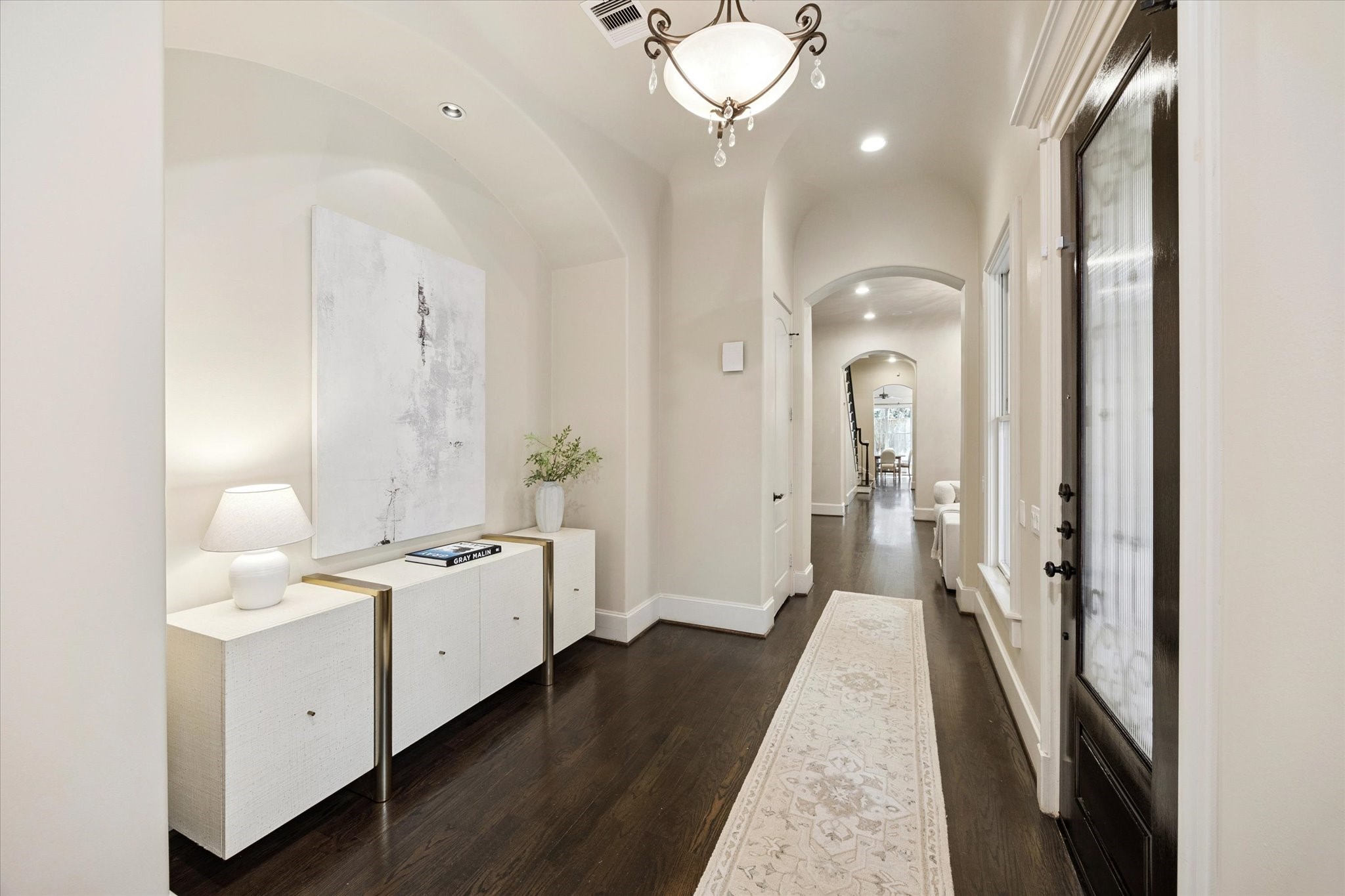 2145 Fairview Street Houston, TX 77019 - Photo 8 of 50 Entryway, looking into the living space with high ceilings and beautiful arched doorways.