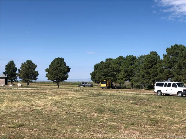 a view of a room with mountain and trees in the background