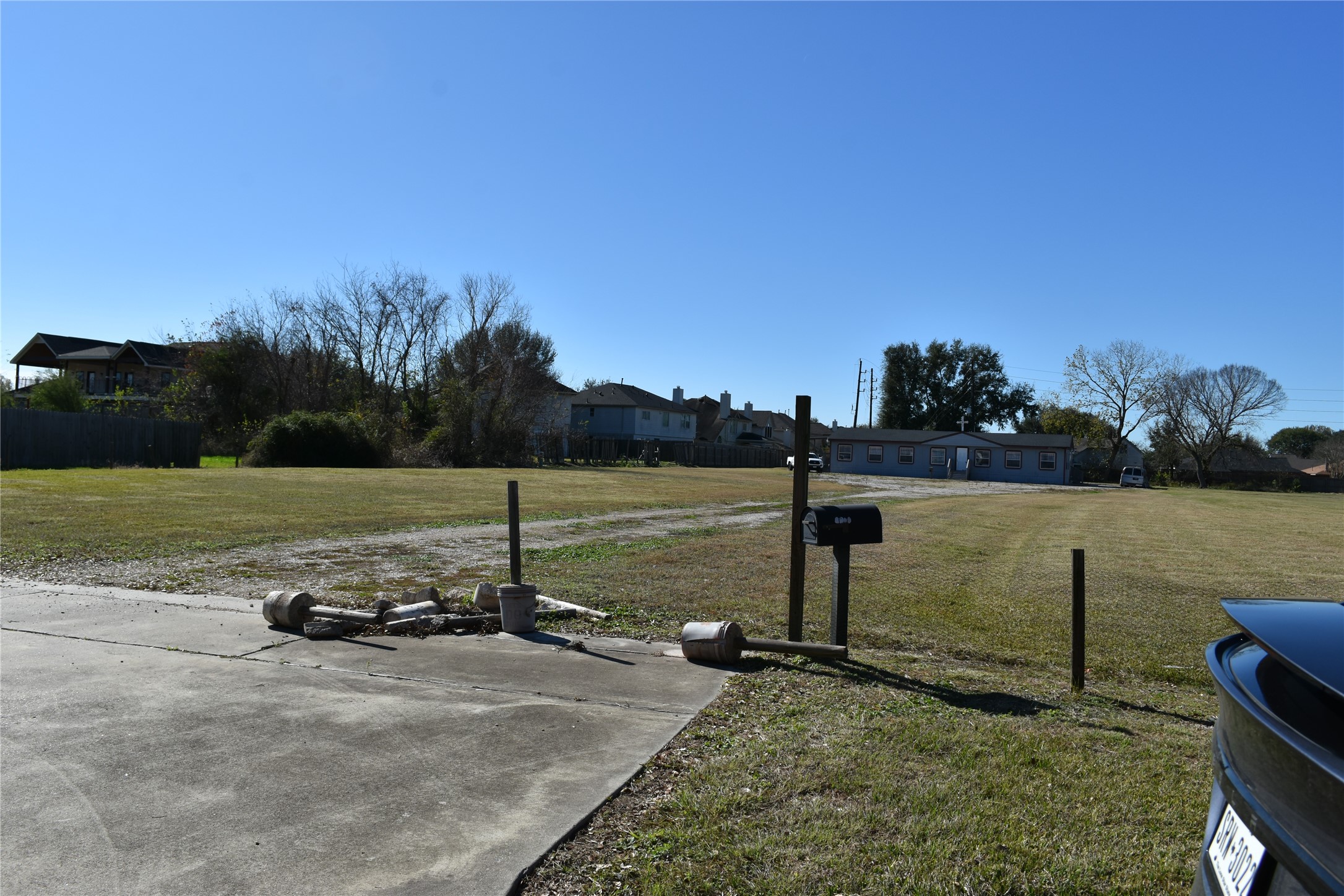 7813 Clodine Road Houston, TX 77083 - Photo 6 of 10 a view of a lake with a yard and large trees