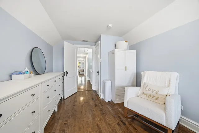 a view of living room with furniture and mirror