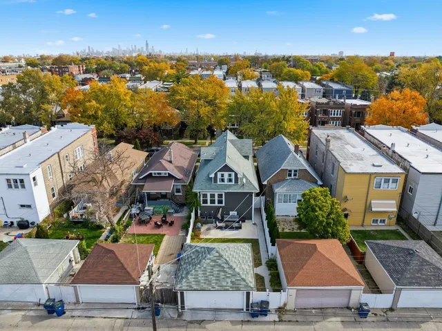 an aerial view of residential houses with outdoor space and parking