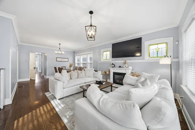 a living room with furniture a fireplace and a flat screen tv