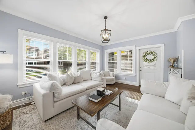 a living room with furniture windows and wooden floor