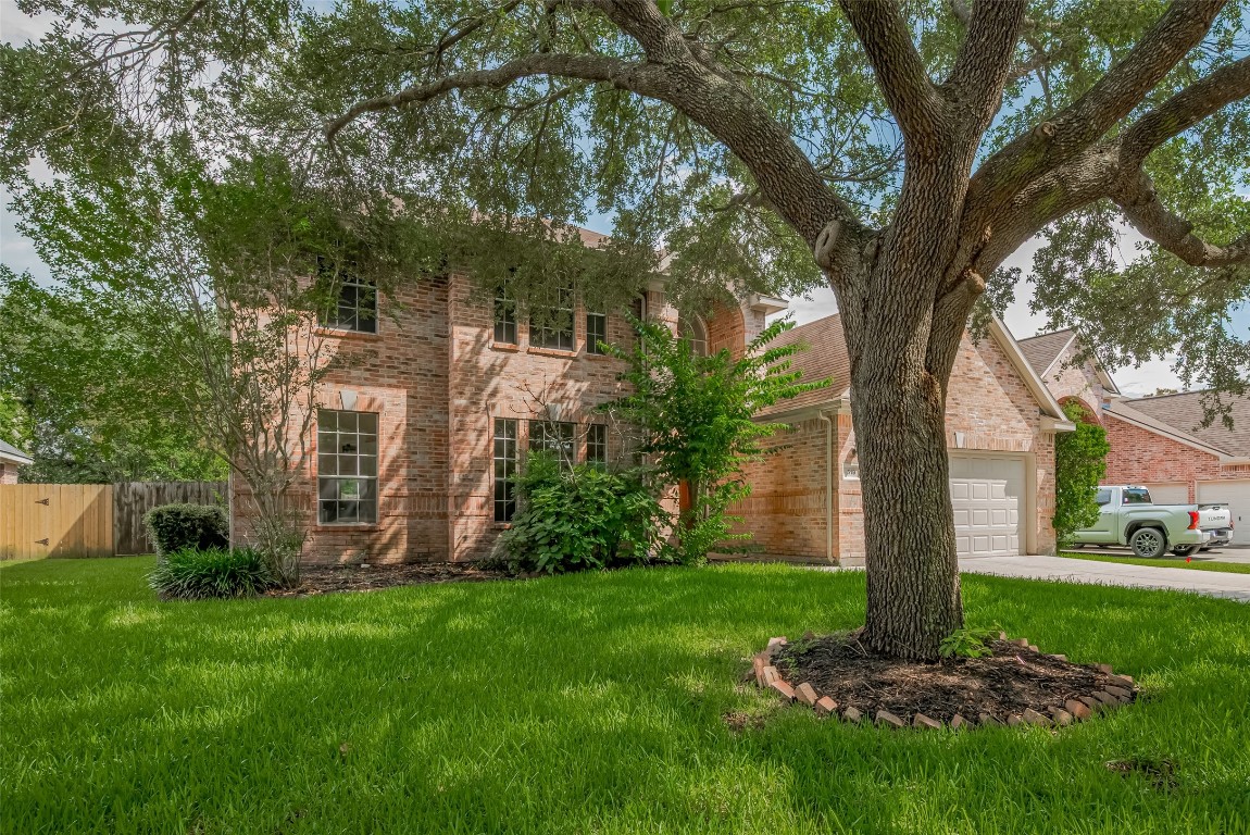 619 Bending Bough Drive Spring, TX 77388 - Photo 2 of 41 a view of a yard in front of a house with a large tree