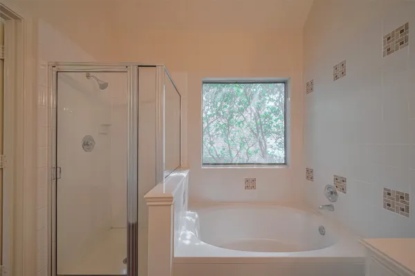 a white bath tub sitting next to a shower
