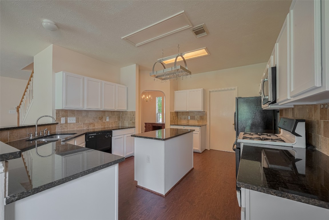 619 Bending Bough Drive Spring, TX 77388 - Photo 10 of 41 a kitchen with stainless steel appliances a sink stove and refrigerator