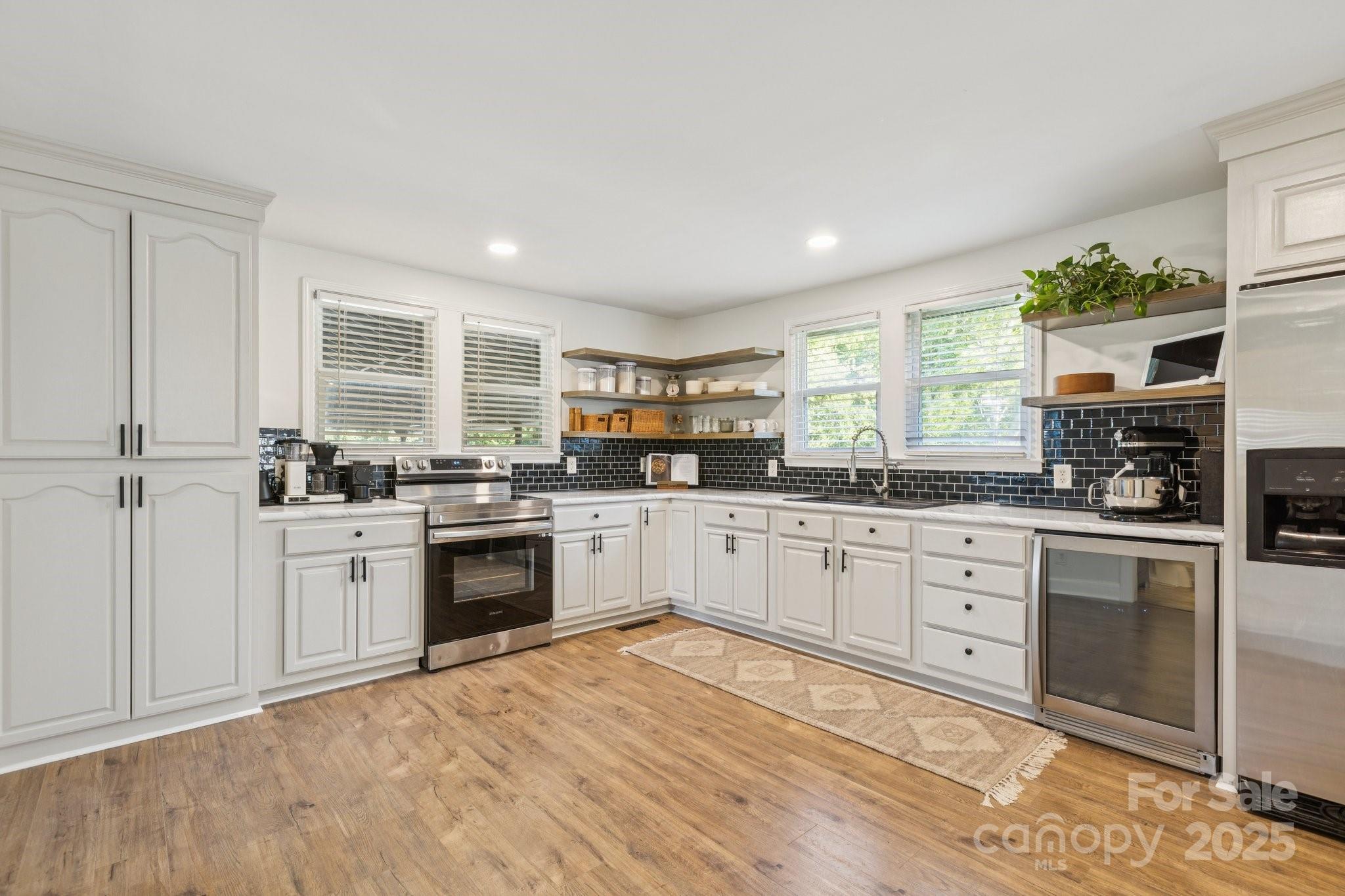 1225 Liberty Road Chester, SC 29706 - Photo 4 of 37 a kitchen with granite countertop white cabinets and white appliances